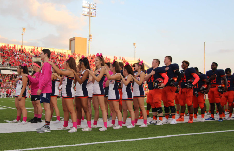 The cheerleaders, football team and flag runners come together for the pledge. This was a display of unison in spirit for Seven Lakes.