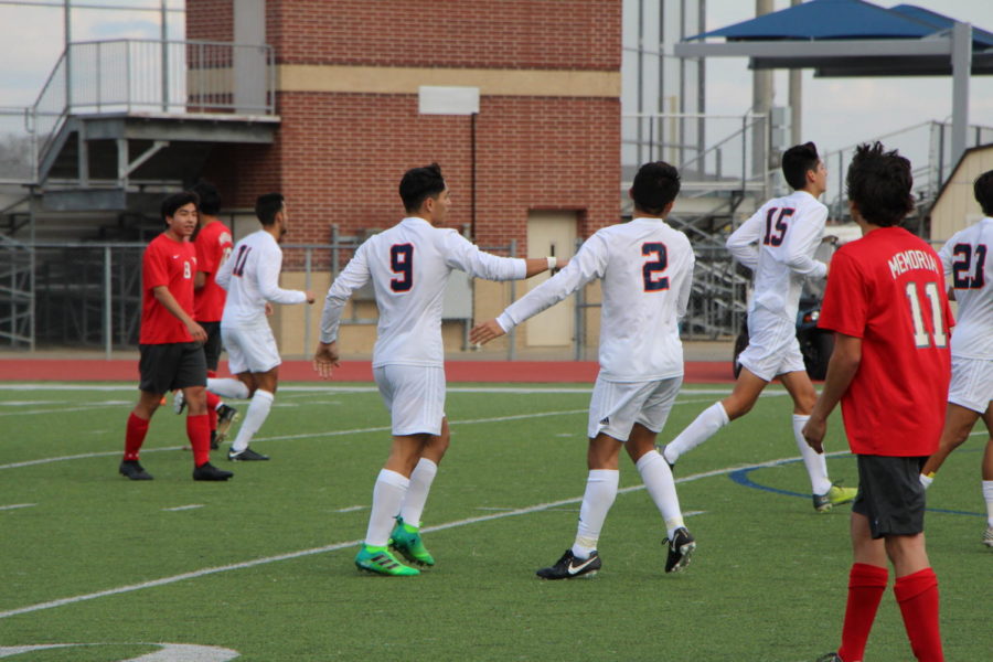 Anthony Romano and Raul Ekmeiro converse on the field.