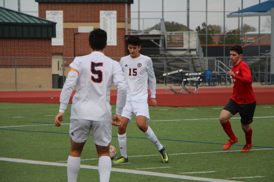 Felipe Ordonez tries to keep the ball away from the opponent. 