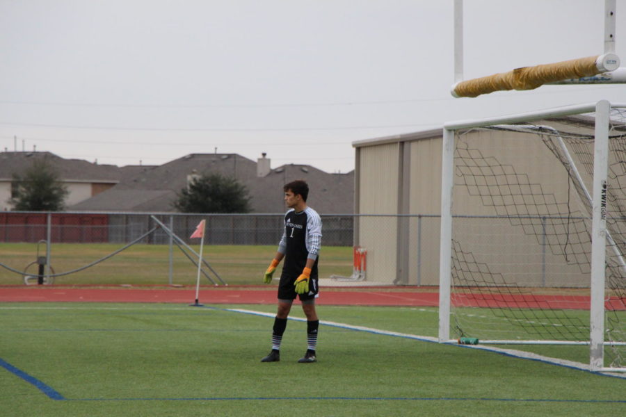 Goalie Charlie Beck watches the game from his position.