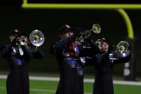 Daniel Fox marches and plays the trumpet in the halftime show in the first Seven Lakes varsity football game versus Memorial.