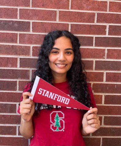 Senior Aayushi Gandhi holds up a flag for Stanford University, which is the college she will be attending in the fall. 
