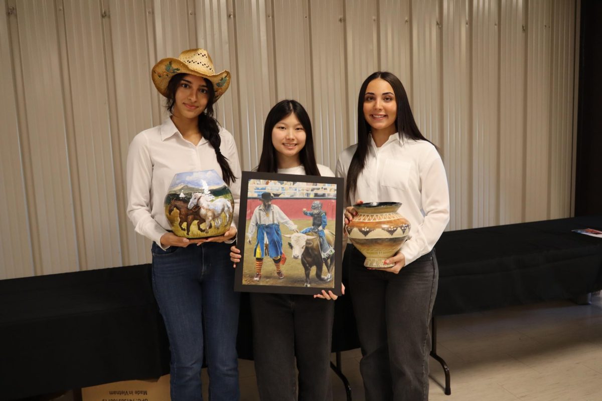 Saina Poures (left), Eumin Park (middle), and Annika Gonzalez (right) hold their art pieces after the Fort Bend County Art Auction. 