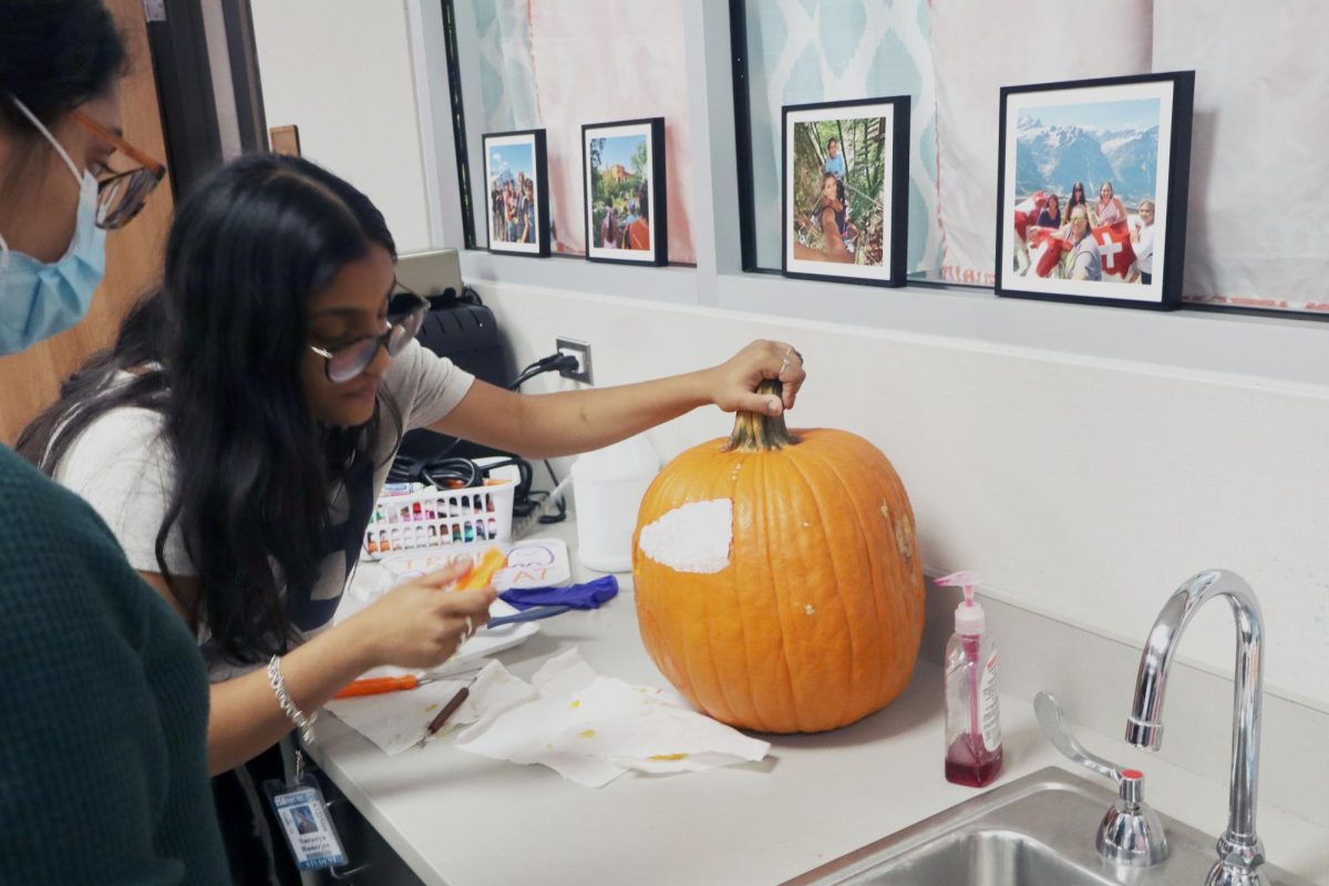 Senior Saranya Ranerjee carves out a pumpkin for Miller Career & Technology Center's annual Monster Mash. 
